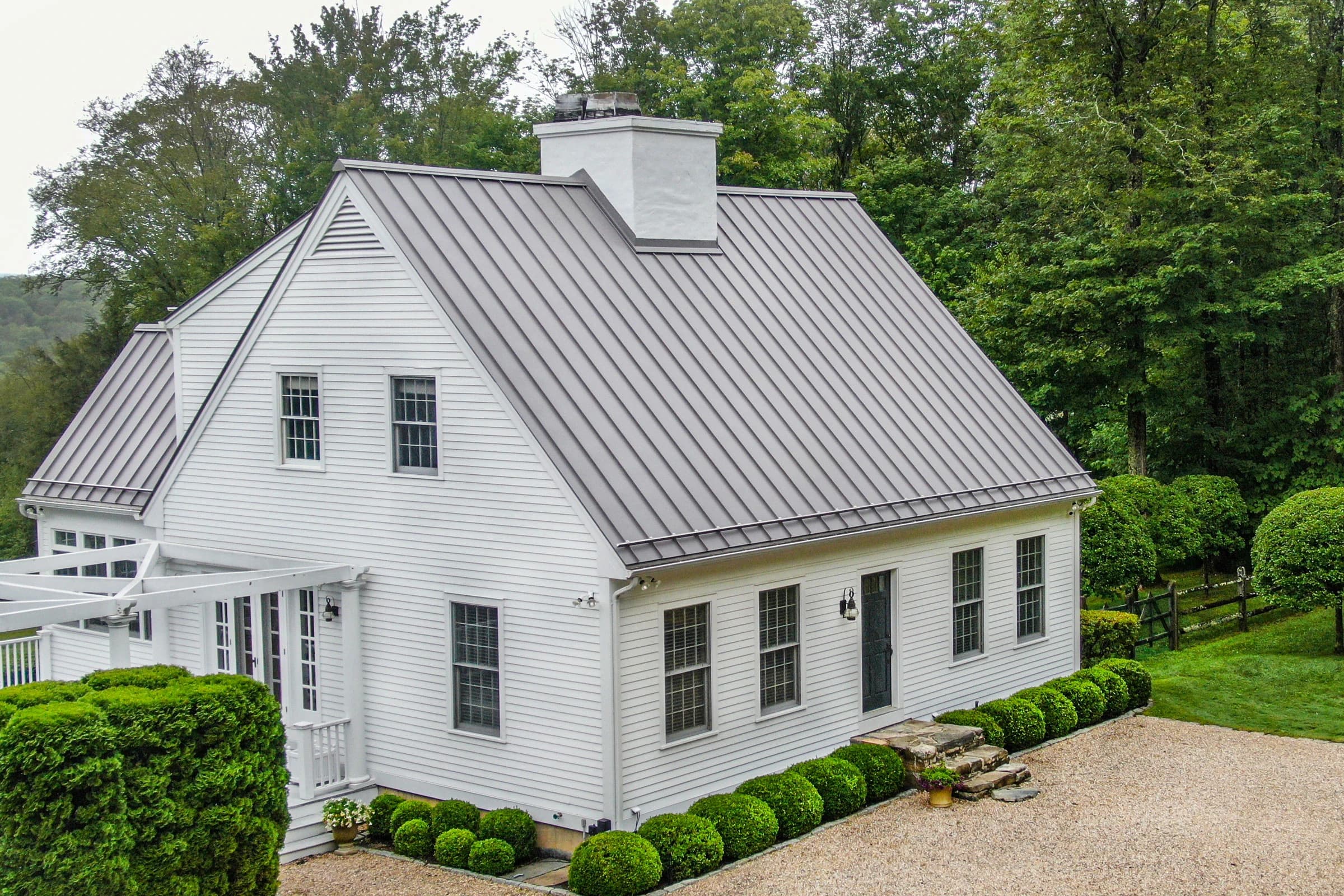 White farmhouse with a new metal roof