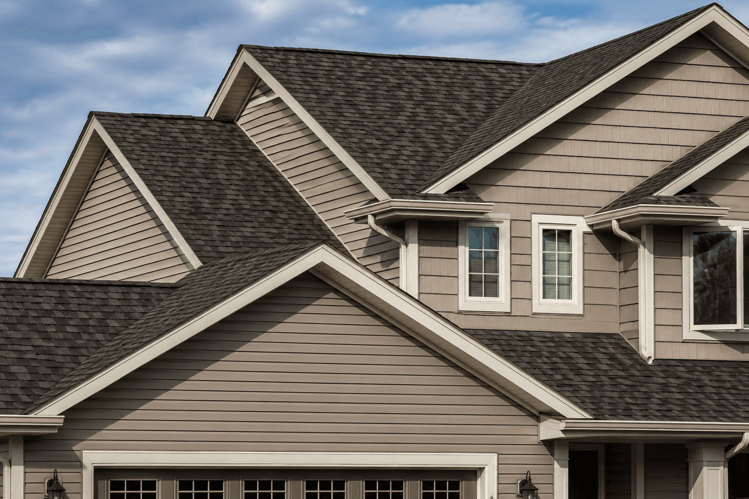 Brown architectural shingles on the gabled roof of a two-storey home