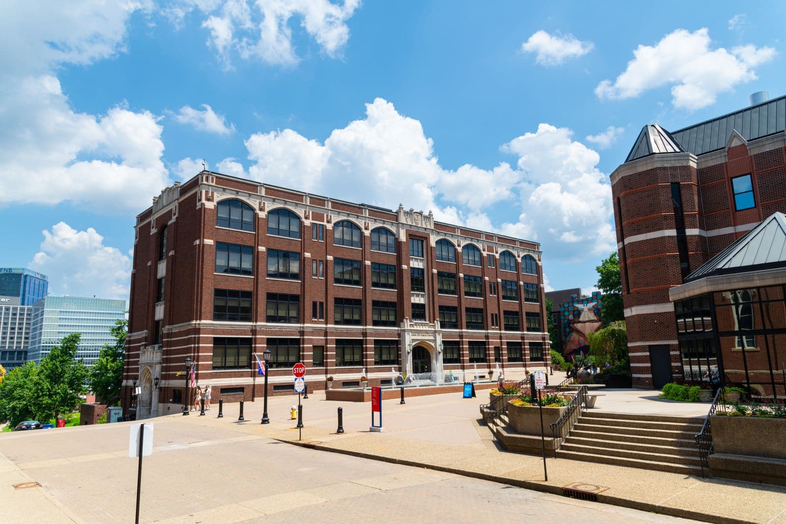 Brick institutional buildings along a civic campus street