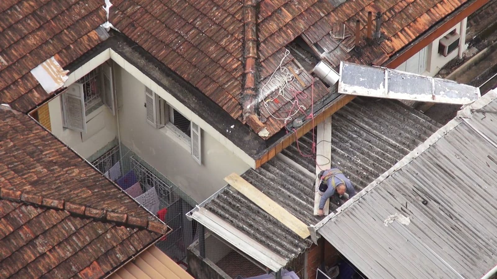 Roofer working across a residential roof during a replacement